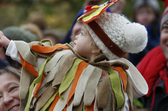 A family watches the Macy's Thanksgiving parade in New York City.