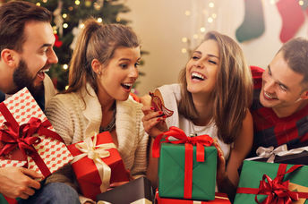 A group of friends celebrate by giving a consumable gift.