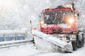 Snowplow clearing highway after a winter storm.