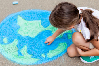 A girl drawing the earth.