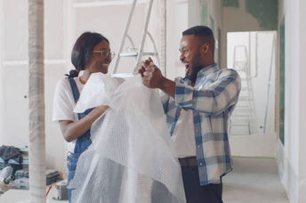 Happy couple having fun with bubble wrap.