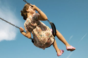 A woman enjoying a swing is a simple pleasure.