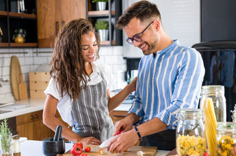 A couple cooking together.