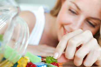 A woman eating jelly candies.