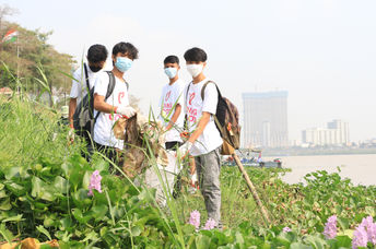 Volunteers cleaning the river bank.