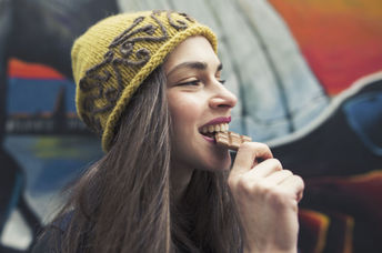 Woman enjoying a chocolate bar.
