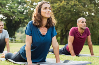 Yoga stretching in a park,