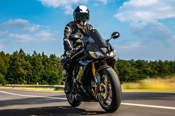 A motorcyclist wearing protective gear.