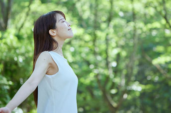 Japanese woman forest bathing.