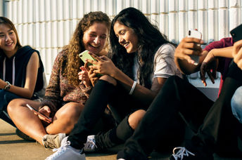 Students using digital devices.