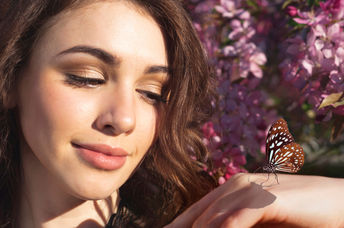 Woman holding a butterfly.