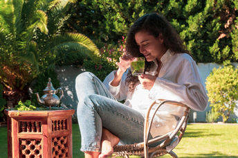 Woman enjoying a cup of mint tea.