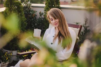 Woman surrounded by greenery.