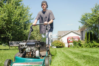 Teen cutting grass for people in need.