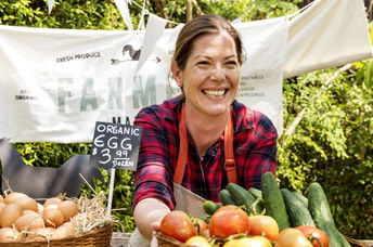 Women selling produce at a famers market.