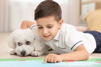 Little girl reading to her pet.