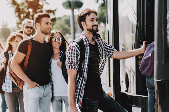 Passangers getting on a bus.