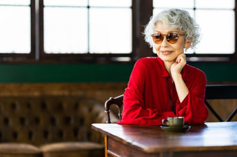 Senior Japanese woman relaxing in a restaurant.