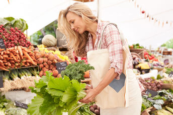 Woman buying vegetables at a farmer's market.