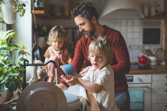 Father and sons washing dishes.
