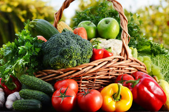 Wicker basket with assorted raw vegetables.