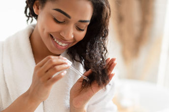 Woman using an organic oil in her hair.