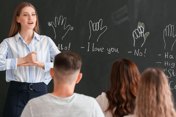 Teacher instructing a class on signing.