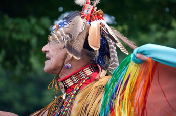 A Native American man from the Pokanoket Wampanoag tribe wearing traditional clothing at a                                   local powwow in Haverhill, Massachusetts, USA.