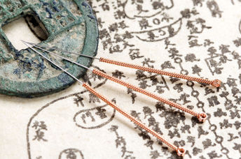 Acupuncture needles and text.