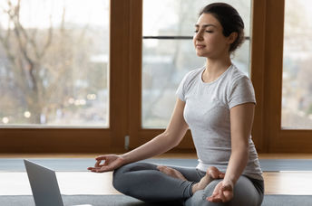 Woman beginning a series of yoga poses to help her get over a cold.