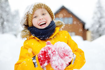 Child playing outside during the winter.