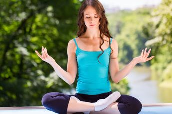 Doing yoga in a park.