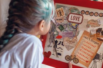 A vision board idea for travel to France is made by a woman who wants to manifest travel.