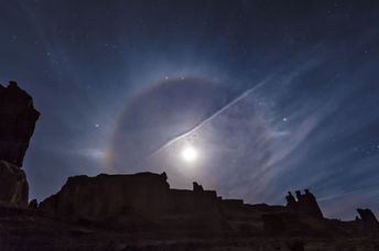 A moon halo over Arches National Park.