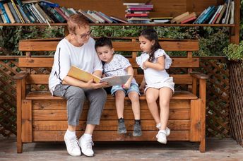 Grandmother reading to her grandchildren.