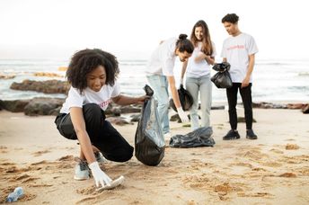 Young volunteers cleaning a beach.