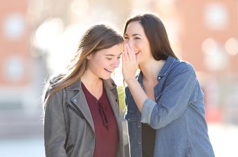 Two friends sharing good news.