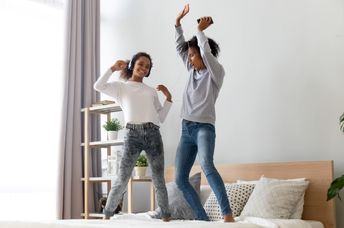 Mother and daughter dancing to golden oldies.