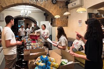 Volunteers in Odessa are packing food boxes for people in need.