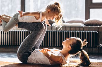 Mother and daughter doing yoga.
