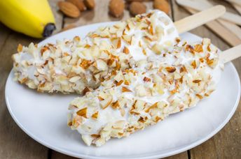 Frozen bananas coated with yogurt and almonds are a healthier choice.