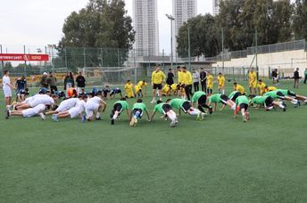 Youth from diverse backgrounds and cultures in Israel play soccer.