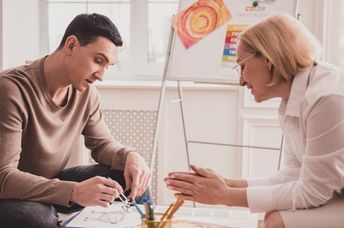 A young man in an art therapy session.