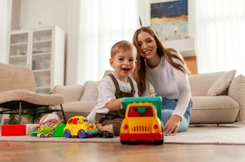 A kid plays with a toy car.