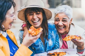 Group of older women enjoying eating together.