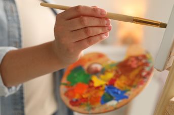 An artist painting a canvas.