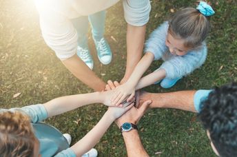 A family enjoying nature are supporting each other, embodying hope.