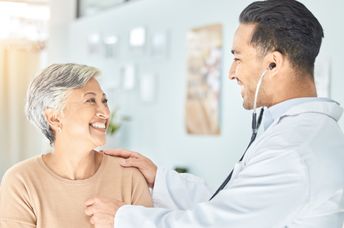 Cardiologist listening to a senior patient’s heart.