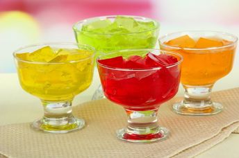 Colorful, synthetically-colored jelly cubes in bowls.