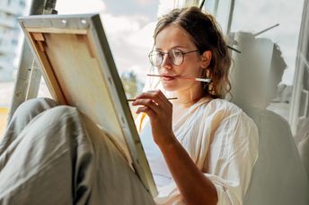 Young mom taking some me time to paint.